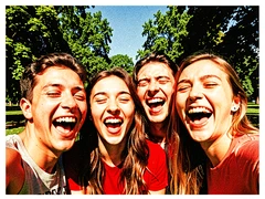 Four friends crowded together taking a selfie outdoors in a sunny park, all laughing and making silly faces, green trees and blue sky visible behind them, warm afternoon sunlight falling evenly across all four faces from the front, casual and spontaneous energy with a sense of genuine fun. Raw photocopy zine aesthetic, brutalist DIY print energy with high-contrast pure white #FFFFFF and pure black #000000, disrupted by aggressive red #FF0000 accents and muted grey #F2F2F2 mid-tones. Flat hard daylight with crushed shadows and no soft falloff. Style: brutalist zine. Mood: confrontational.